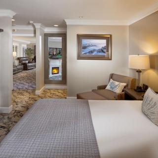 Best Western Plus Humboldt Bay Inn | Eureka, California | King bed beside chair and side table with brown dresser