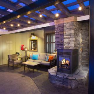 Best Western Plus Humboldt Bay Inn | Eureka, California | Beige outdoor furniture beside stone fireplace