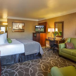 Best Western Plus Humboldt Bay Inn | Eureka, California | Two double beds beside couch, armchair, work desk, TV and dresser