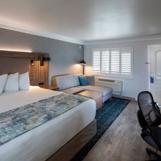 Best Western Plus Humboldt Bay Inn | Eureka, California | King bed with white pillows and multi-colored accent blanket